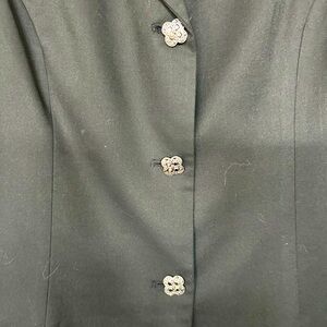 Tailored pantsuit, black with jeweled buttons.